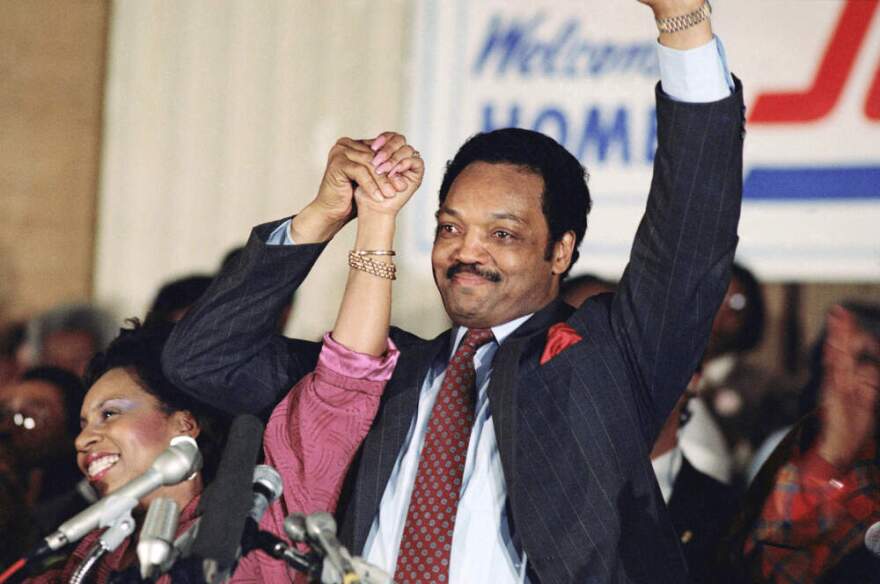 Democratic presidential hopeful Jesse Jackson with his wife, Jacqueline, salutes the cheering crowd at Operation Push in Chicago, March 10, 1988. (Fred Jewell/AP)
