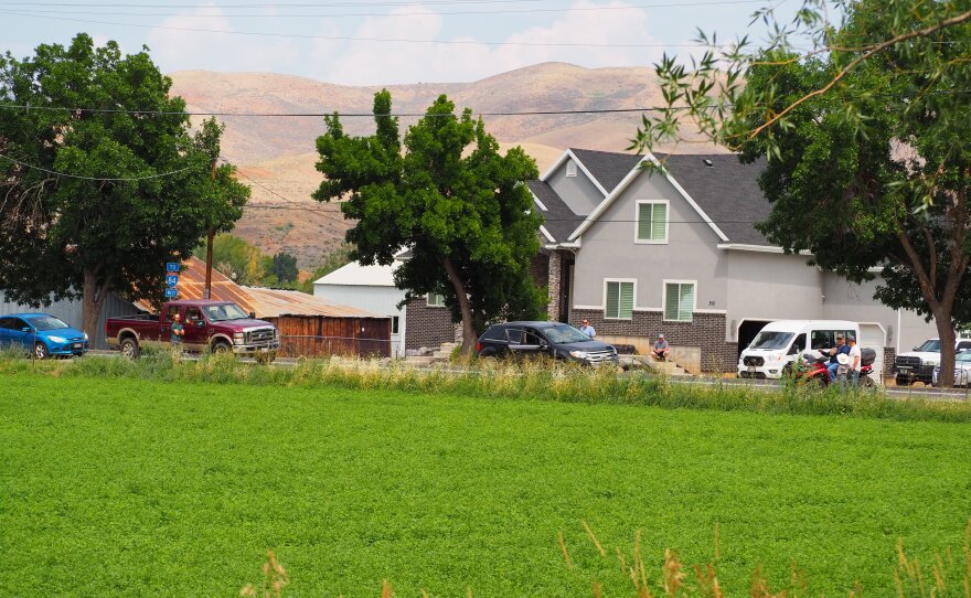 Residents gather along Main Street in Henefer, watching the Rocky Canyon Fire on Aug. 10, 2026.