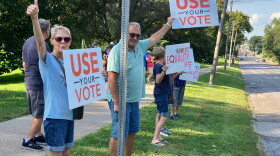 Protestors against the federal SAVE Act line Brady Street at Vander Veer Park, on Aug. 26, 2026.