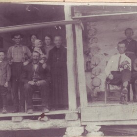 Frank Vess Portell family. The woman with the guitar is Nellie Hopkins Portell. She is wearing button shoes, and has the Gibson Girl hairstyle. The man with the fiddle is Francis "Brazz" Politte. His descendants are known as the Brazz Polittes.