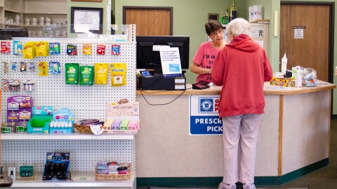 An associate serves a customer at the counter of independently owned Gateway Pharmacy, located in Clare, Michigan, on Monday, May 4, 2026.