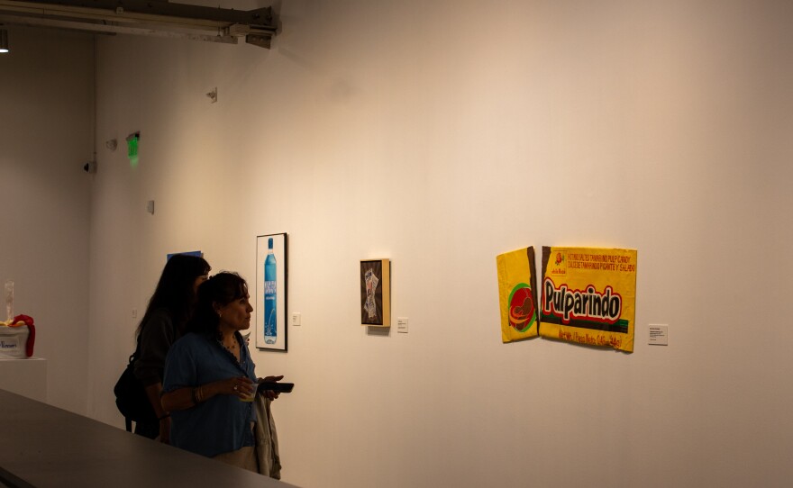 Guests looking at a large Pulparindo candy artwork.