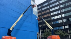 Workers painter over the 1999 mural by Wyland titled "Ocean Life," also known as Whaling Wall 82, on May 15, 2026.