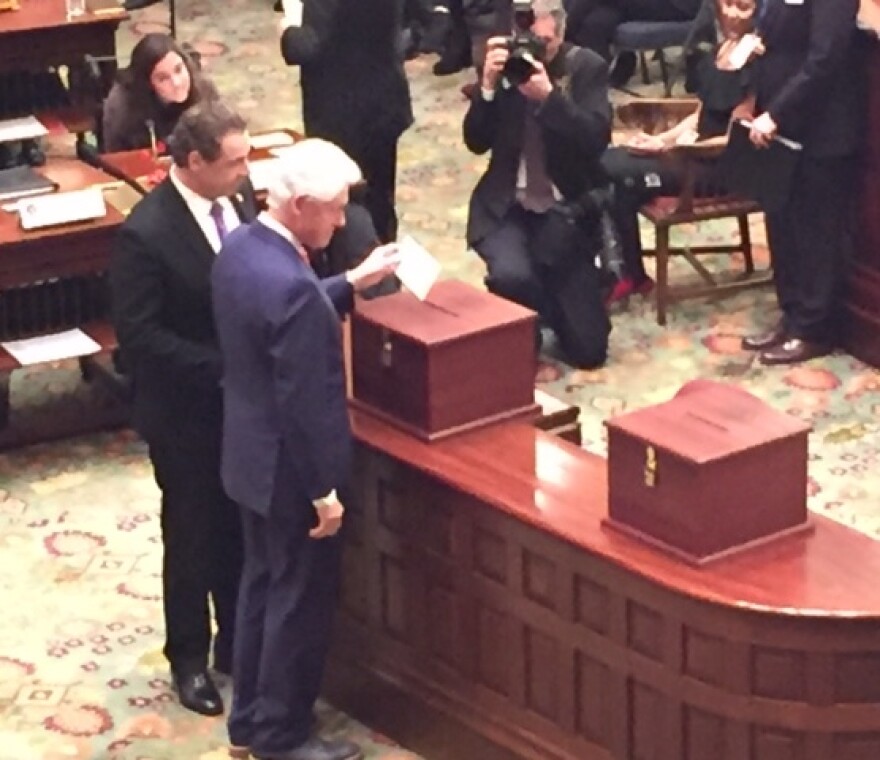 Former President Bill Clinton casts his vote for his wife, Democratic presidential candidate Hillary Clinton, at New York's Electoral College meeting in Albany on Monday.