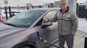 State. Sen. Jeff Smith, (D-Eau Claire County) stands next to his Chevrolet Equinox EV, as it receives a charge at a Kwik Trip in Chippewa Falls.