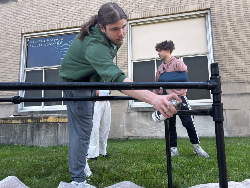 Niagara Falls High School seniors spray paint the base of a table in the school’s construction class.