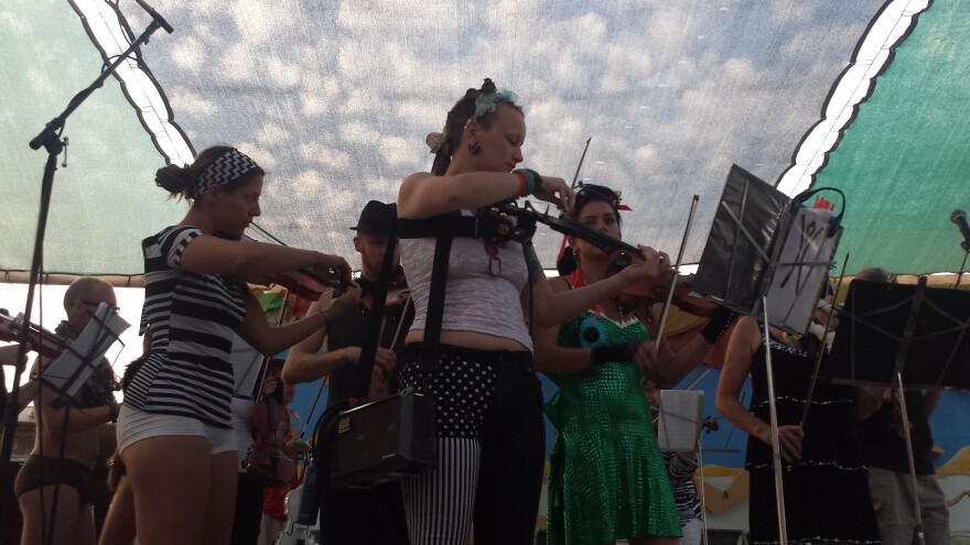 First-chair violinist Madelaine Ripley and other musicians in the Playa Pops Symphony warm up before a 2014 performance.