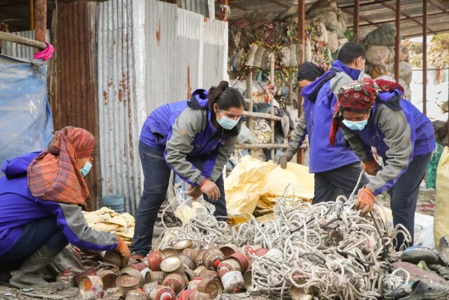 Workers separate waste collected from the mountains at the waste storage site in Tokha, Kathmandu.