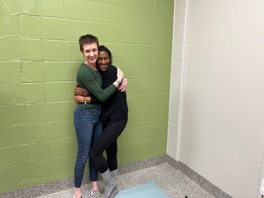 Ashley Krstulovich and Bridget Harden hug after a yoga session at Helping Hands.