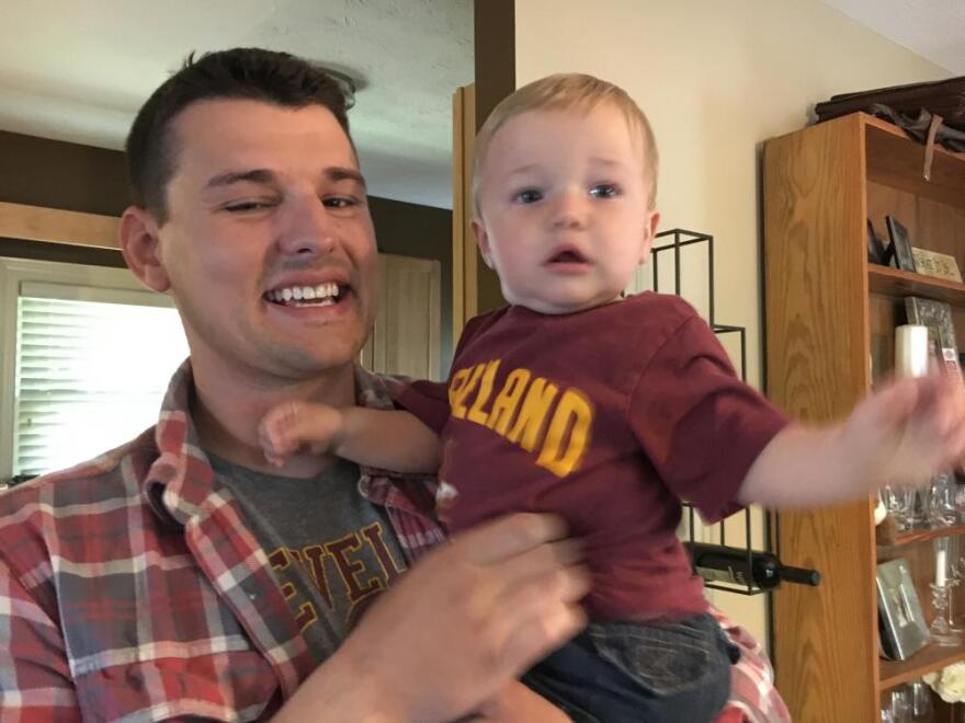 Nick Brown is holding his son Will. He attended a Bootcamp for New Dads class before Will was born. (Darrielle Snipes/ideastream)