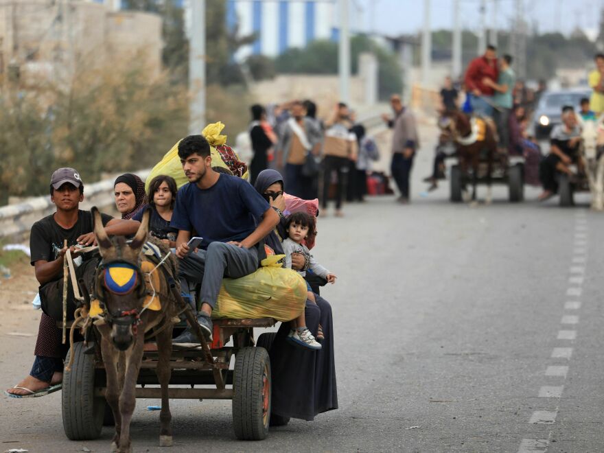 Palestinians arrive south of Gaza City on Sunday after fleeing their homes amid the ongoing battles between Israel and the militant group Hamas.