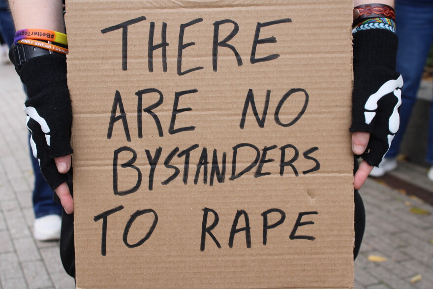 A sign held at a rally for Jane Doe in Ithaca, New York. October 4, 2026
