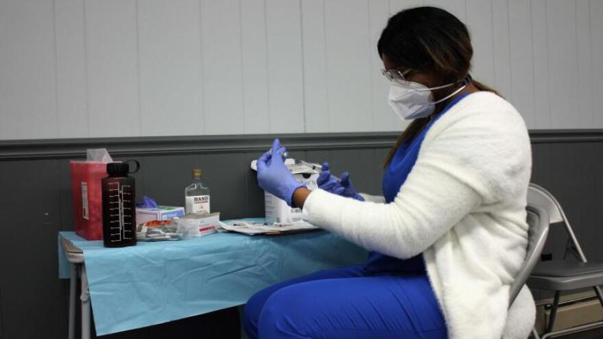 Melissa White, a medical assistant with Prism Health Lab, draws up a dose of the Pfizer-BioNTech vaccine at a COVID-19 pop-up clinic in Cobden, Ill., on Feb. 27.