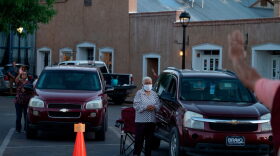 Parishioners take wave hello to each other as a sign of peace, instead of the customary shaking hands, outside the Basilica of San Albino in Mesilla New Mexico, amid the coronavirus pandemic. 