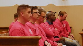 Santa Fe County firefighters wait to give public comment during a Board of County Commissioners meeting