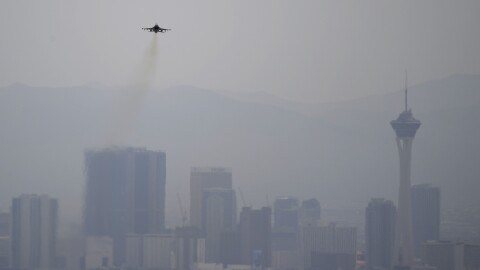 A fighter jet takes off from Nellis Air Force Base as a haze blankets the Las Vegas valley, Tuesday, July 31, 2018, in Las Vegas. Dense smoke from a series of wildfires burning in California has triggered air quality alerts across more than a 400-mile stretch of Nevada from Reno to Las Vegas. (AP Photo/John Locher)