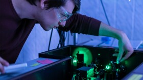 Scientist works with laser machine.