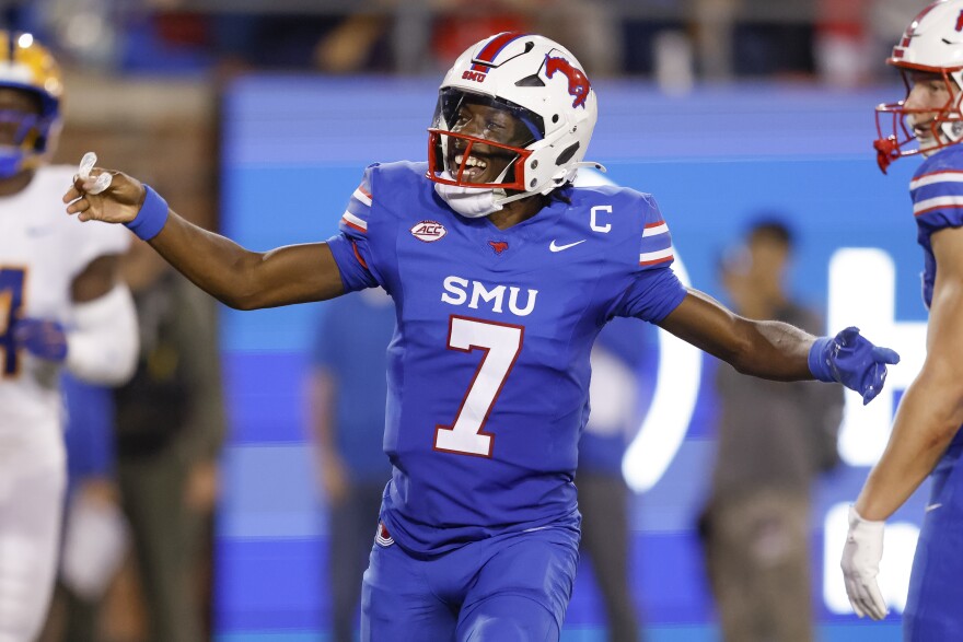 A man in a blue football uniform with the letter "S-M-U" and the number 7 on his chest celebrates.