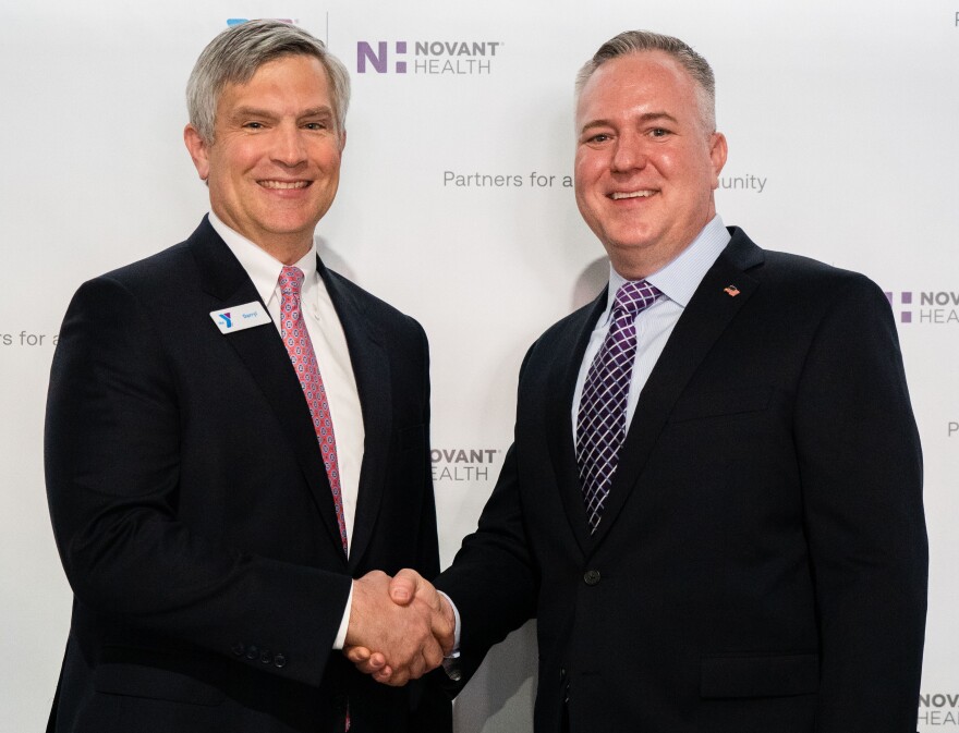 Darryl Head, president and CEO of the YMCA of Northwest North Carolina, shakes hands with Chad Setliff, senior vice president and president Novant Health Forsyth Medical Center and the greater Winston-Salem market, during an announcement of an expanded partnership between the two organizations. Image courtesy of Novant Health.