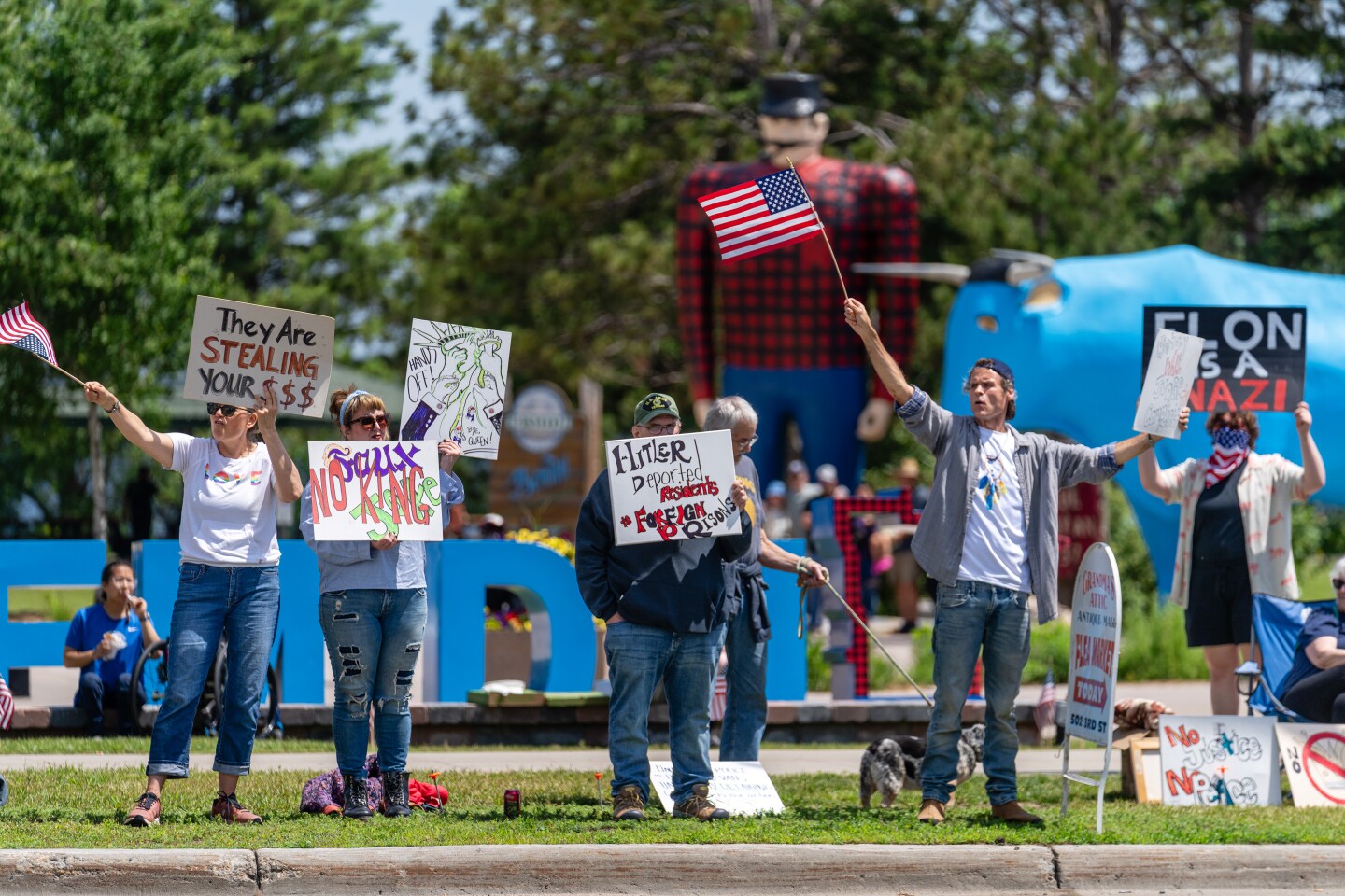 Protesters hold signs in Downtown Bemidji, part of the "No Kings" protest in Bemidji on Saturday, June 14, 2025.