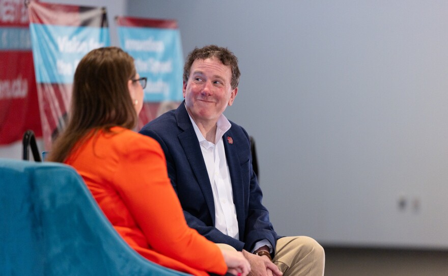 Dr. Daniel Corr smiles beside Dr. Kristina Diaz at the fireside chat.