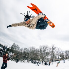 Professional snowboarder Zeb Powell soars above the slopes in Beech Mountain, North Carolina.