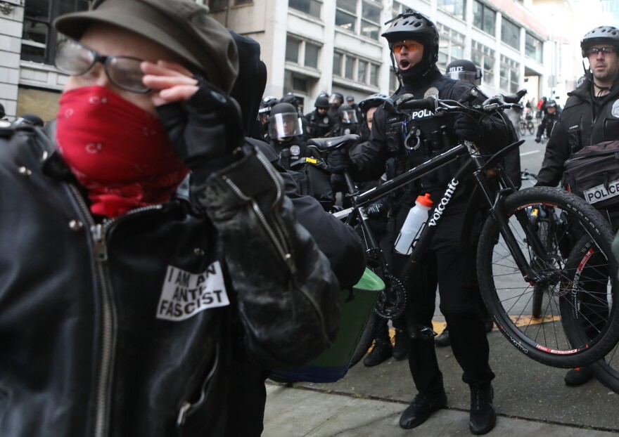 Seattle police officers use mountain bikes as crowd control devices while attempting to disperse anti-fascist protesters during the United Against Hate rally in Seattle last month.