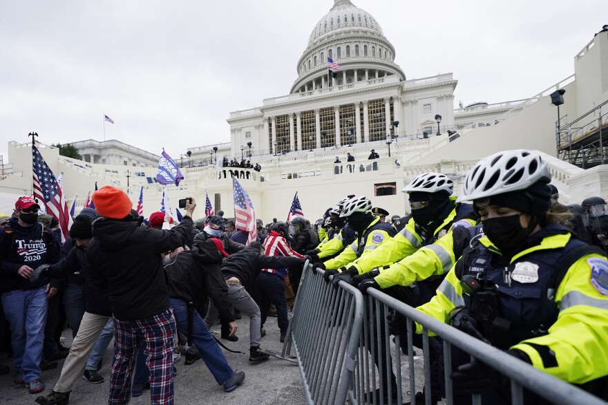 Trump supporters try to break through a police barrier at the Capitol in Washington, D.C., on Wednesday. As Congress prepares to affirm President-elect Joe Biden's victory, thousands of people have gathered to show their support for President Trump.