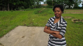 Sherry Laskey stands near land she bought in a north Tulsa neighborhood. Laskey is hoping to turn the empty lot into a profitable community garden that provides healthy food for the area.
