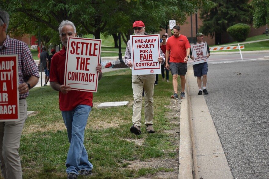 EMU faculty picket outside dorms during student move-in day.