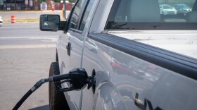 A truck fills up at a gas station in Salt Lake City. Fuel prices are still averaging almost a dollar more per gallon than last year.