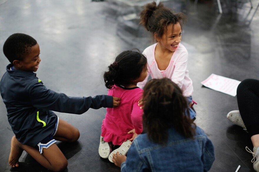 Erica Brown's children, JaCorey Landheart, 7 (left), Jazmine Brown, 8 (top right), and Cal'Rhyanna Brown, 6 (foreground), play with another girl at the convention center.