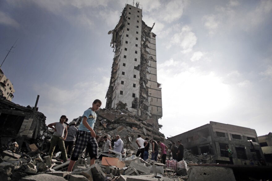 Palestinians inspect the damage to the Italian Complex following several late-night Israeli airstrikes in Gaza City on Tuesday.