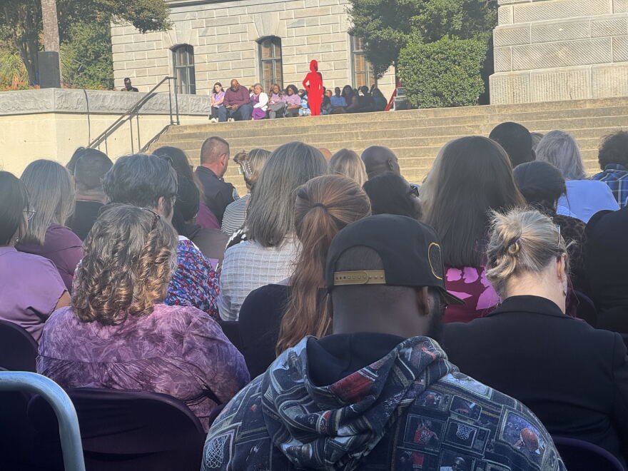 Attendees at the 2026 Silent Witness Ceremony on the Statehouse grounds in Columbia join together in prayer to honor victims of domestic violence and remember those who lost their lives.