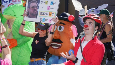 Demonstrators take part in a "No Kings" protests in Medford on Oct. 18, 2025.