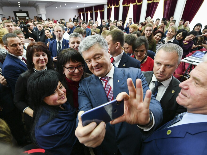 Ukrainian President Petro Poroshenko takes a selfie with students in Kiev, Ukraine, on March 25. He is struggling for second place against veteran politician Yulia Tymoshenko.