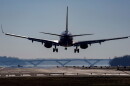 A plane lands on a runway.