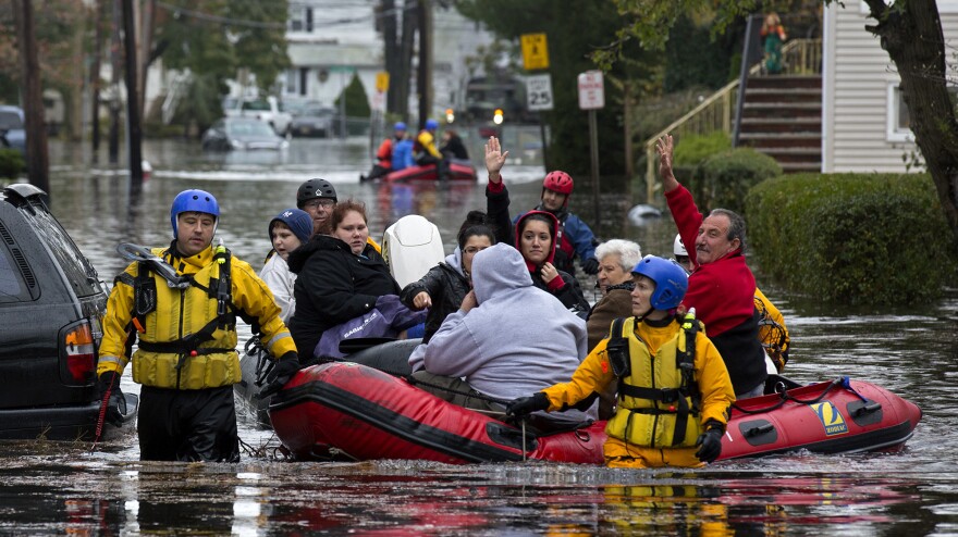 First responders rescue flood-stranded people in Little Ferry, N.J., on Tuesday.