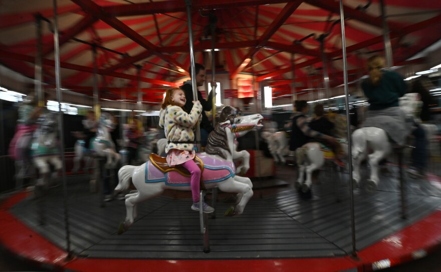 A young girl rides the carousel at the PA Farm Show.