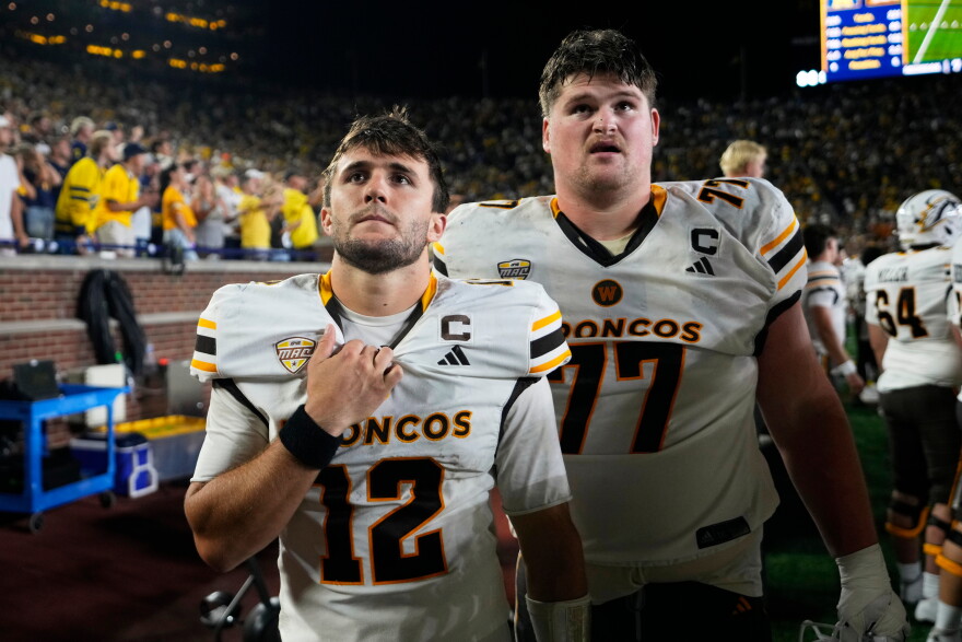 Western Michigan quarterback Broc Lowry (12) and Hunter Whitenack (77) watch from the bench at the end of the second half of an NCAA college football game against Michigan Saturday, Sept. 5, 2026, in Ann Arbor, Mich.