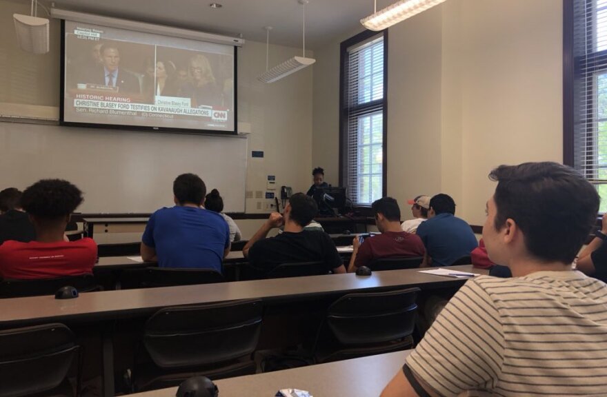 Ruthanne DeGrange, 19 (right), watches the Kavanaugh-Ford hearing in her American history class at the University of Florida. (Danielle Ivanov/WUFT News)