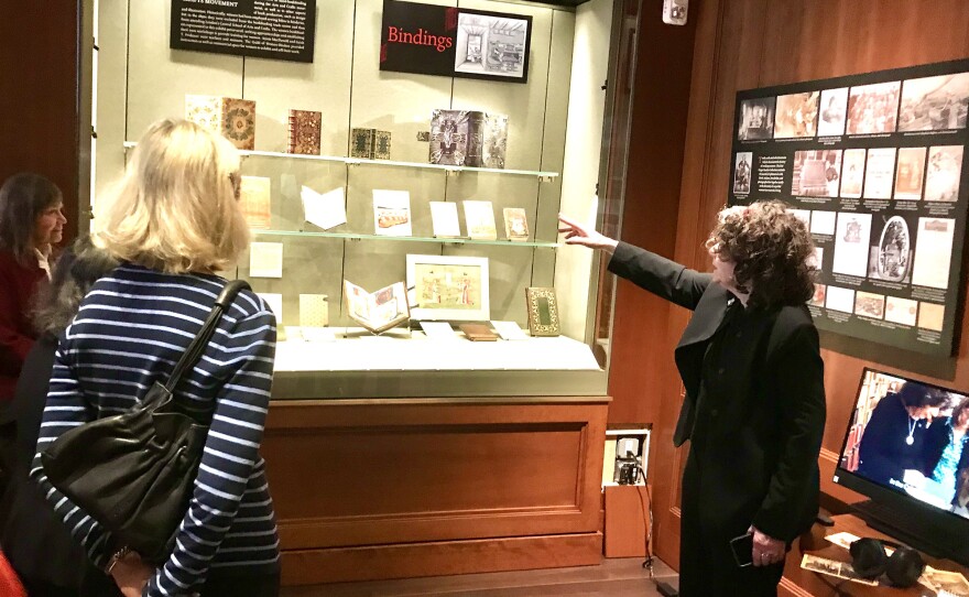 Lisa Unger Baskin shows visitors to an exhibit at the Grolier Club examples of books made by women through the centuries.