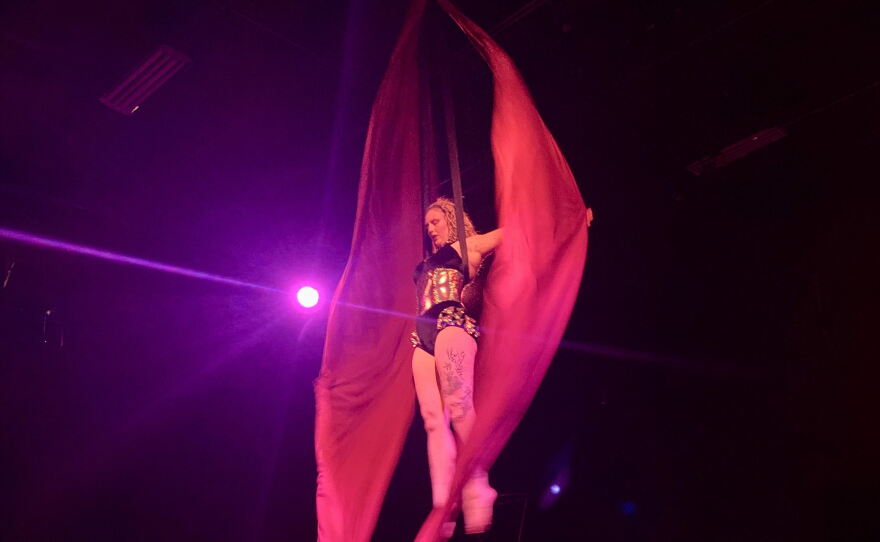 Georgia Ackerman opens the show as Lady Firefly on the aerial silks.