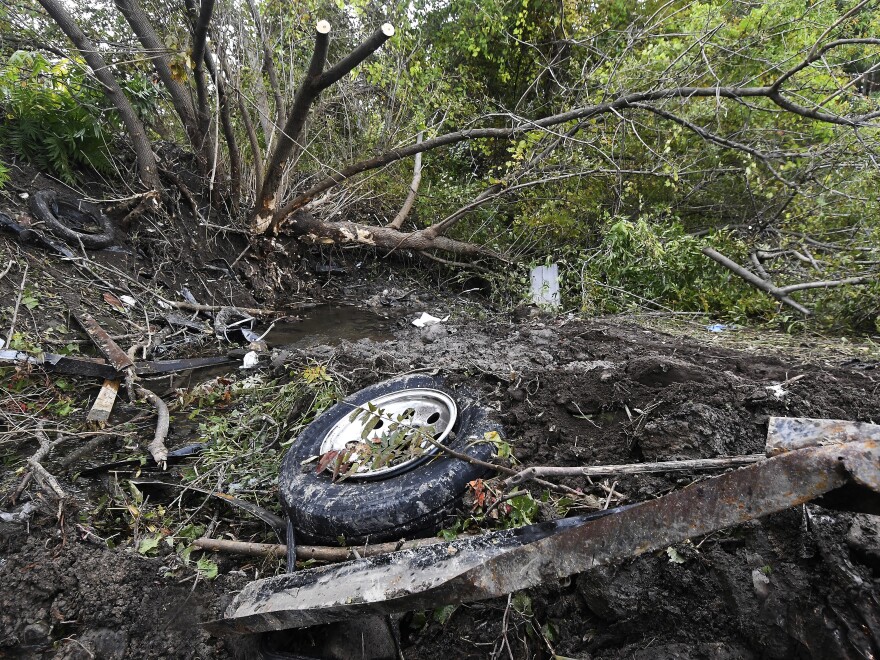 Debris litters the scene of the limousine crash last weekend in Schoharie, N.Y. On Wednesday, Nauman Hussain, identified by police as the operator of Prestige Limousine, was taken into custody.