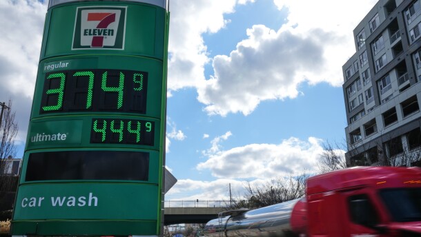 Fuel prices are displayed on a sign at a gas station as a fuel truck drives by, March 17, 2026, in Baltimore. (AP Photo/Stephanie Scarbrough, File)