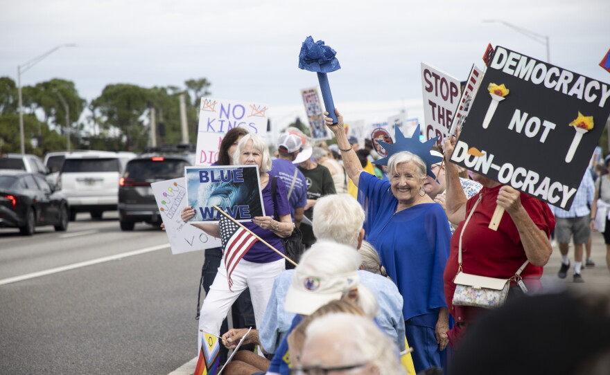People gather along U.S. 41 in Fort Myers on Saturday morning, October 17, 2026, to advocate for change ahead of the mid-term elections. Organizers estimate about 1,000 people came out for the event.