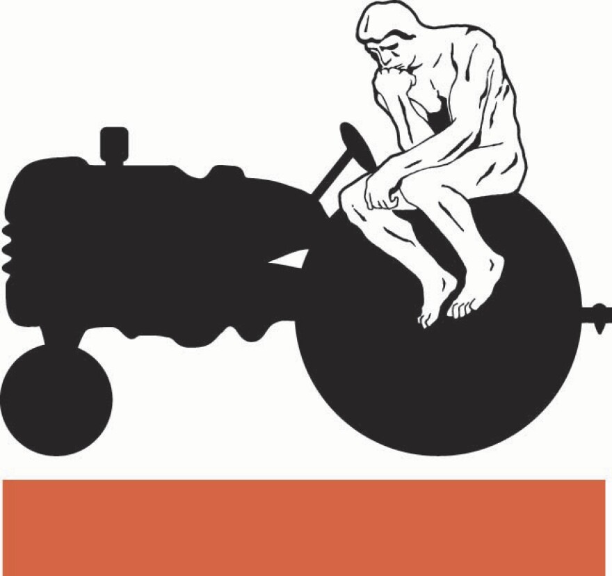 "The Thinker" statue depicted on a farm tractor
