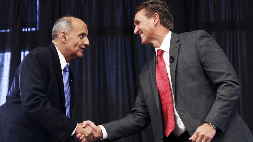 Democrat Richard Carmona (left) and Republican Rep. Jeff Flake shake hands before Thursday's debate in Chandler, Ariz.