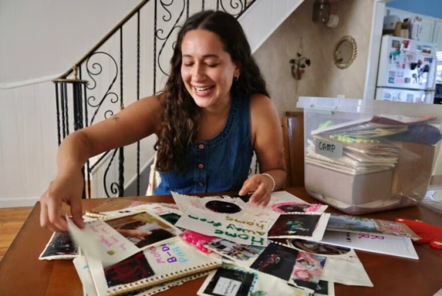 Photograpger Rachel Wisniewski sorts through materials from her stays at Camp Nah-Jee-Wah.