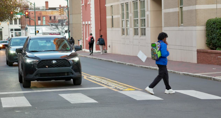 A pedestrian walks past a recently installed turn hardening lane on VCU's campus. 
